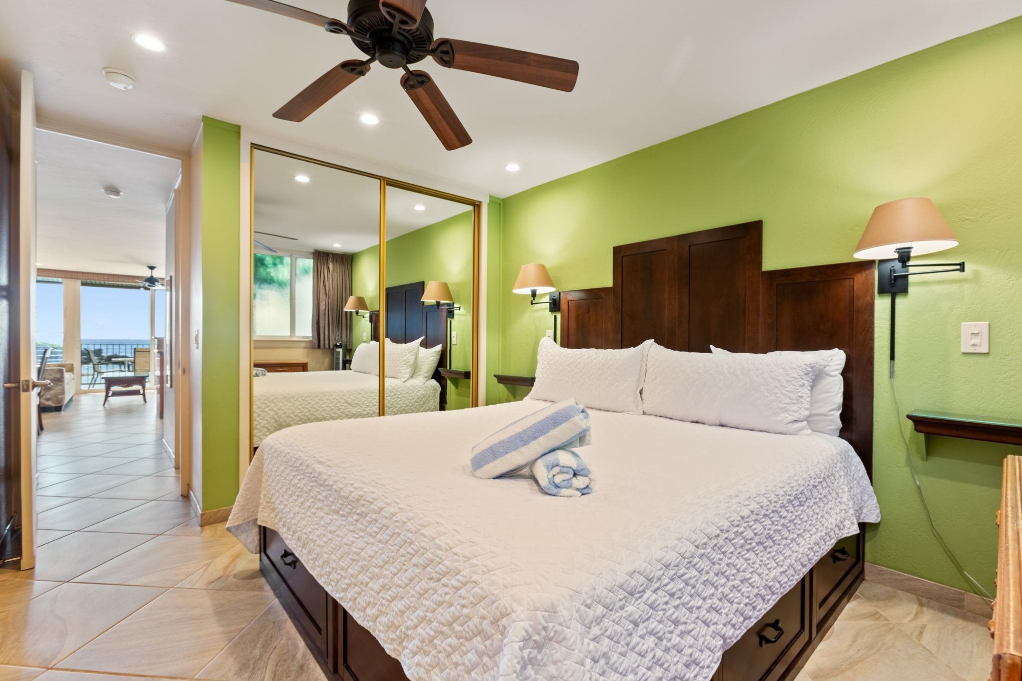 5255 Lower Honoapiilani Road, Unit 119 Lahaina, HI 96761 - Photo 9 of 22 a large bedroom with a bed and glass walk in closet