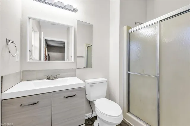 a bathroom with a toilet a sink and a mirror