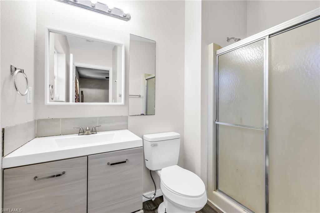 4015 16th Avenue Southeast Naples, FL 34117 - Photo 7 of 22 a bathroom with a toilet a sink and a mirror