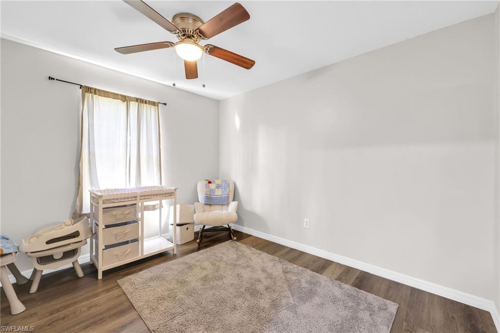4015 16th Avenue Southeast Naples, FL 34117 - Photo 8 of 22 a view of livingroom with hardwood floor and ceiling fan