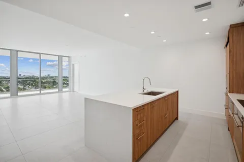 a view of a kitchen with a sink and a window
