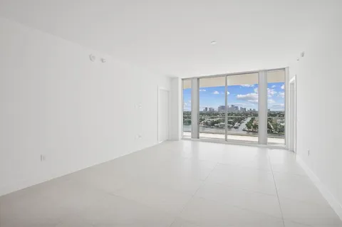 a view of an empty room with a floor to ceiling window and a room