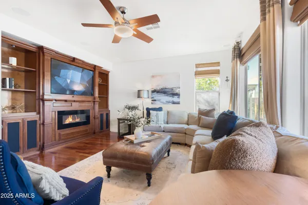 a living room with furniture a fireplace and a large window