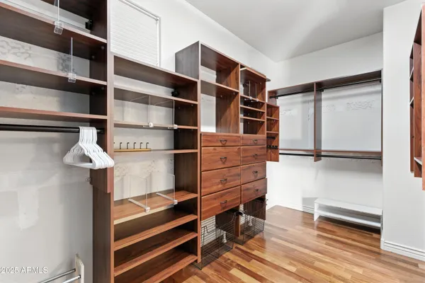 a view of a workspace with furniture and wooden floor