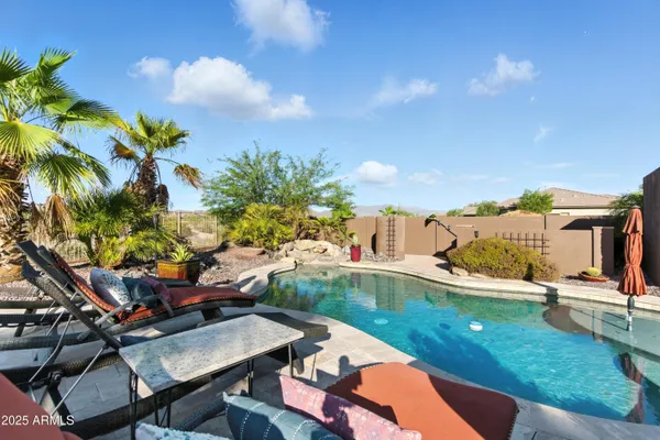 a view of a backyard with sitting area