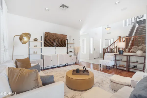 a living room with furniture and a wooden floor