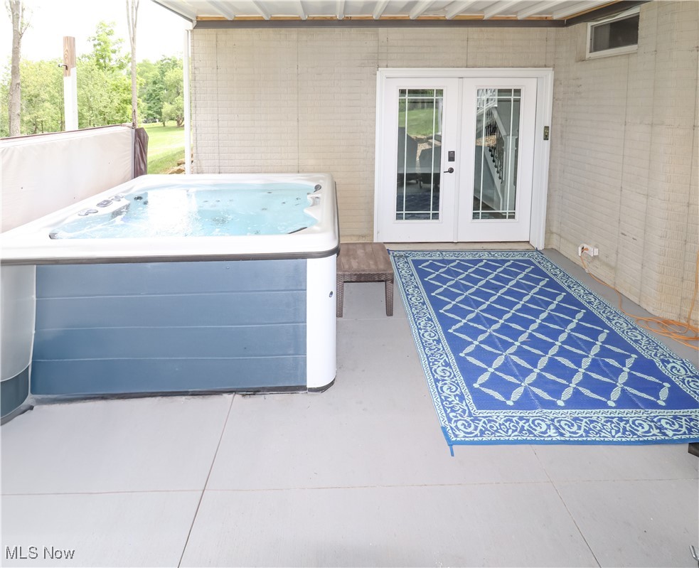 7186 Ridge Road Wadsworth, OH 44281 - Photo 33 of 45 Hot tub on cement patio at the walk-out entrance to the basement