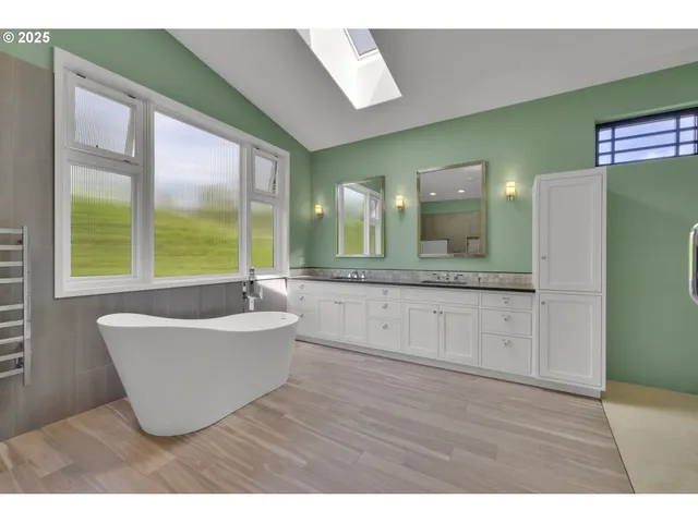 a bathroom with a bathtub sink and mirror