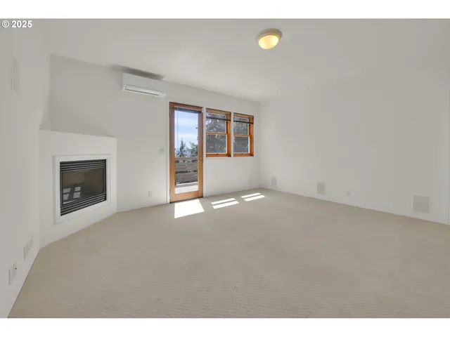 a view of empty room with a fireplace