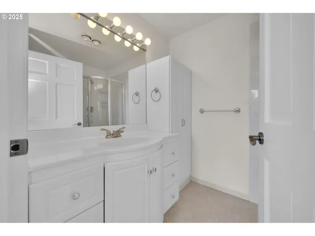 a bathroom with a double vanity sink and a mirror