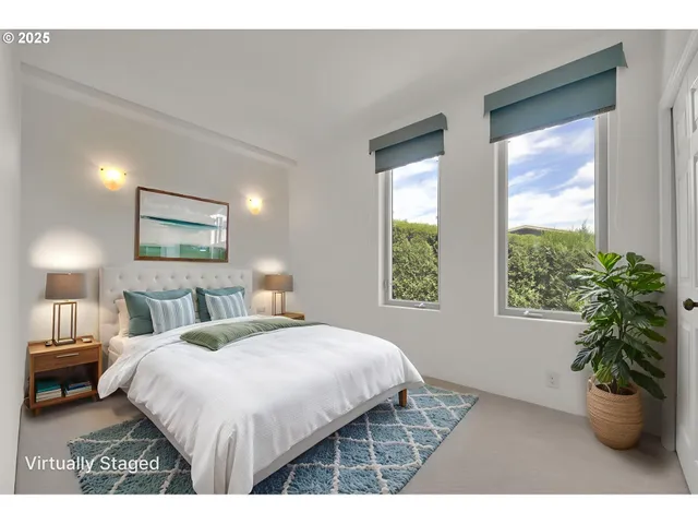 a bedroom with a bed and a potted plant