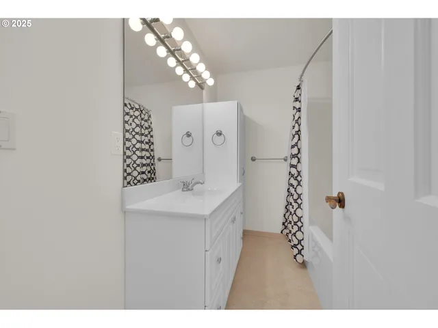 a bathroom with a sink a mirror and a shower