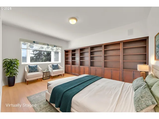 a bedroom with a bed and a large window