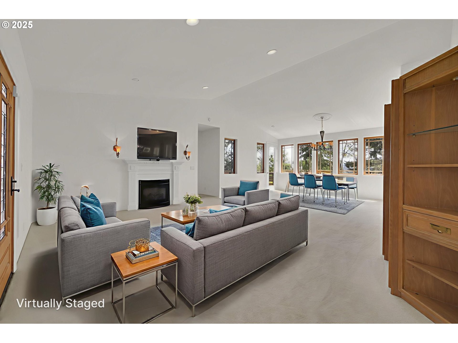 835 Willacade Court Springfield, OR 97477 - Photo 5 of 48 a living room with furniture a fireplace and a flat screen tv