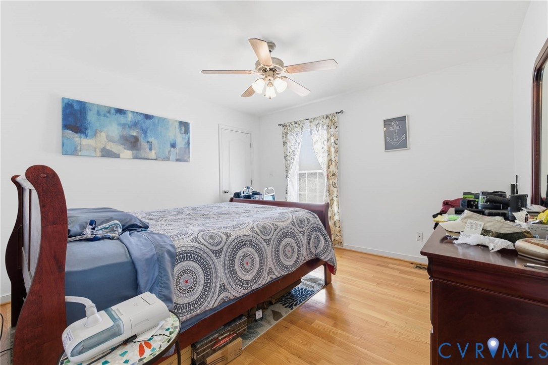 15900 Nobles Road Disputanta, VA 23842 - Photo 13 of 36 Bedroom featuring light hardwood floors and a ceil