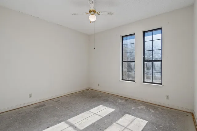 an empty room with windows and closet