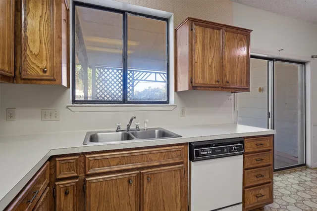 a kitchen with stainless steel appliances a sink stove and cabinets