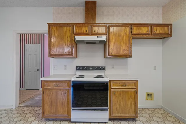 a kitchen with stainless steel appliances granite countertop a stove and a microwave
