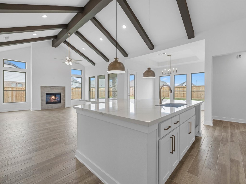 132 Meadow Beauty Lane Georgetown, TX 78633 - Photo 2 of 19 a kitchen with stainless steel appliances granite countertop a lot of counter space and wooden floors