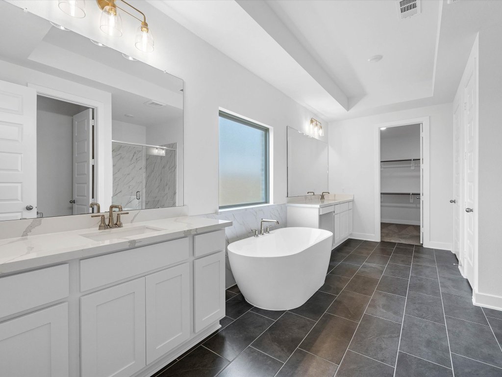132 Meadow Beauty Lane Georgetown, TX 78633 - Photo 8 of 19 a spacious bathroom with a double sink sink mirror and bathtub