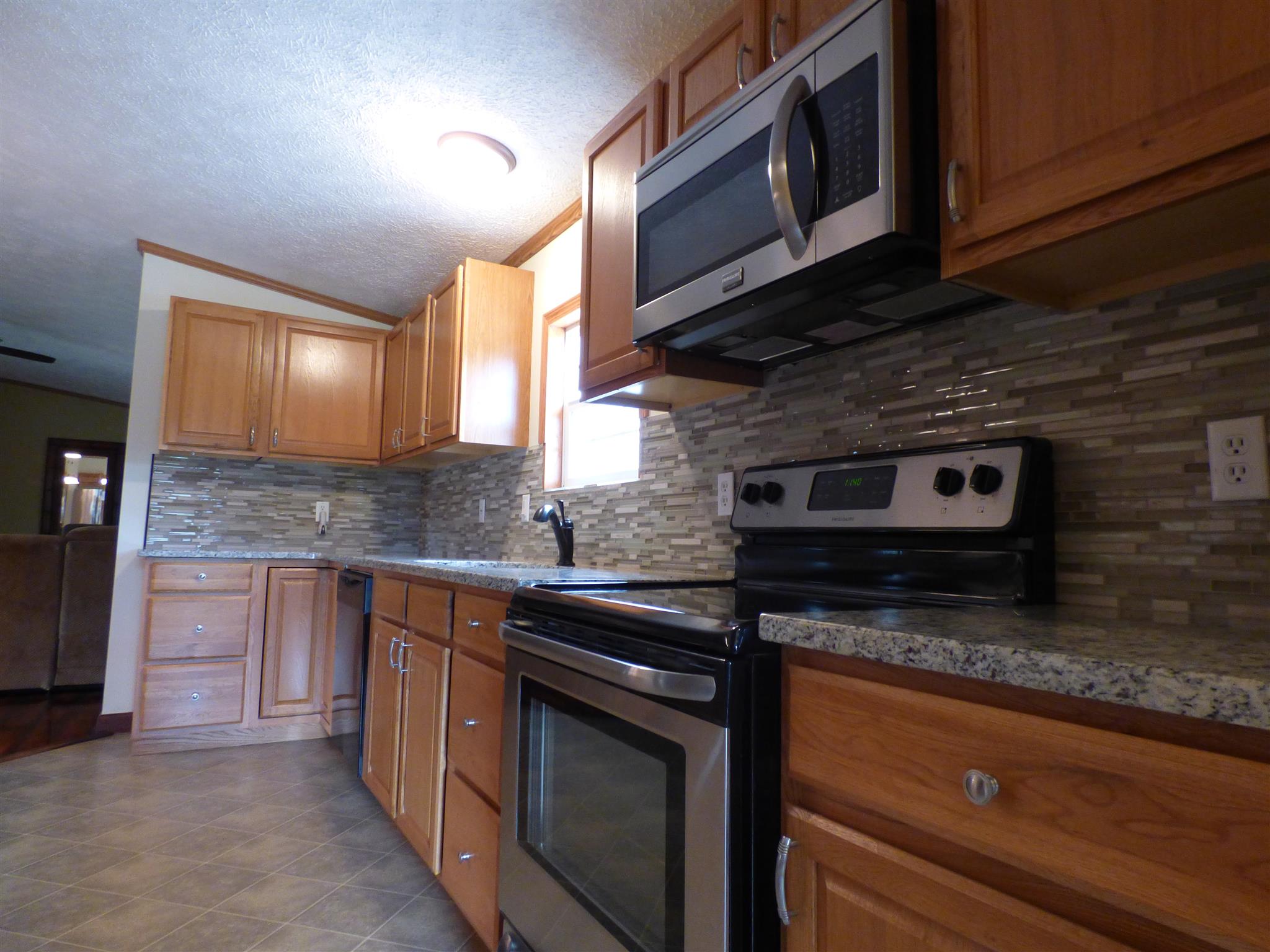 2022 Miller Crossroads Road Hillsboro, TN 37342 - Photo 23 of 24 The kitchen features granite and tile backsplash.