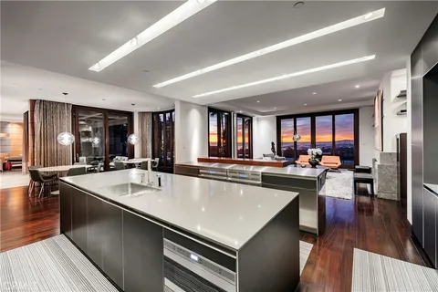 a view of a a dining room with furniture window and wooden floor