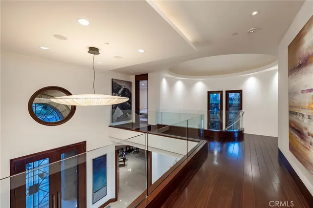 a bedroom with a bed and large windows