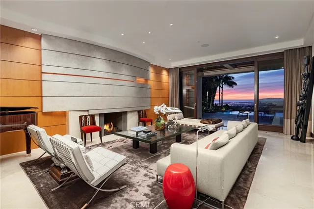 a living room with fireplace furniture and a large window
