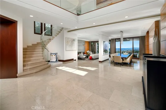 a view of a livingroom with furniture and a large window