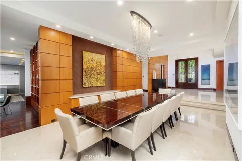 a dining room with furniture and a large window
