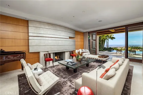 a living room with furniture and a floor to ceiling window