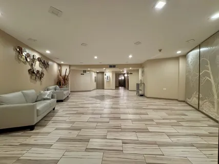 a large room with lots of white furniture