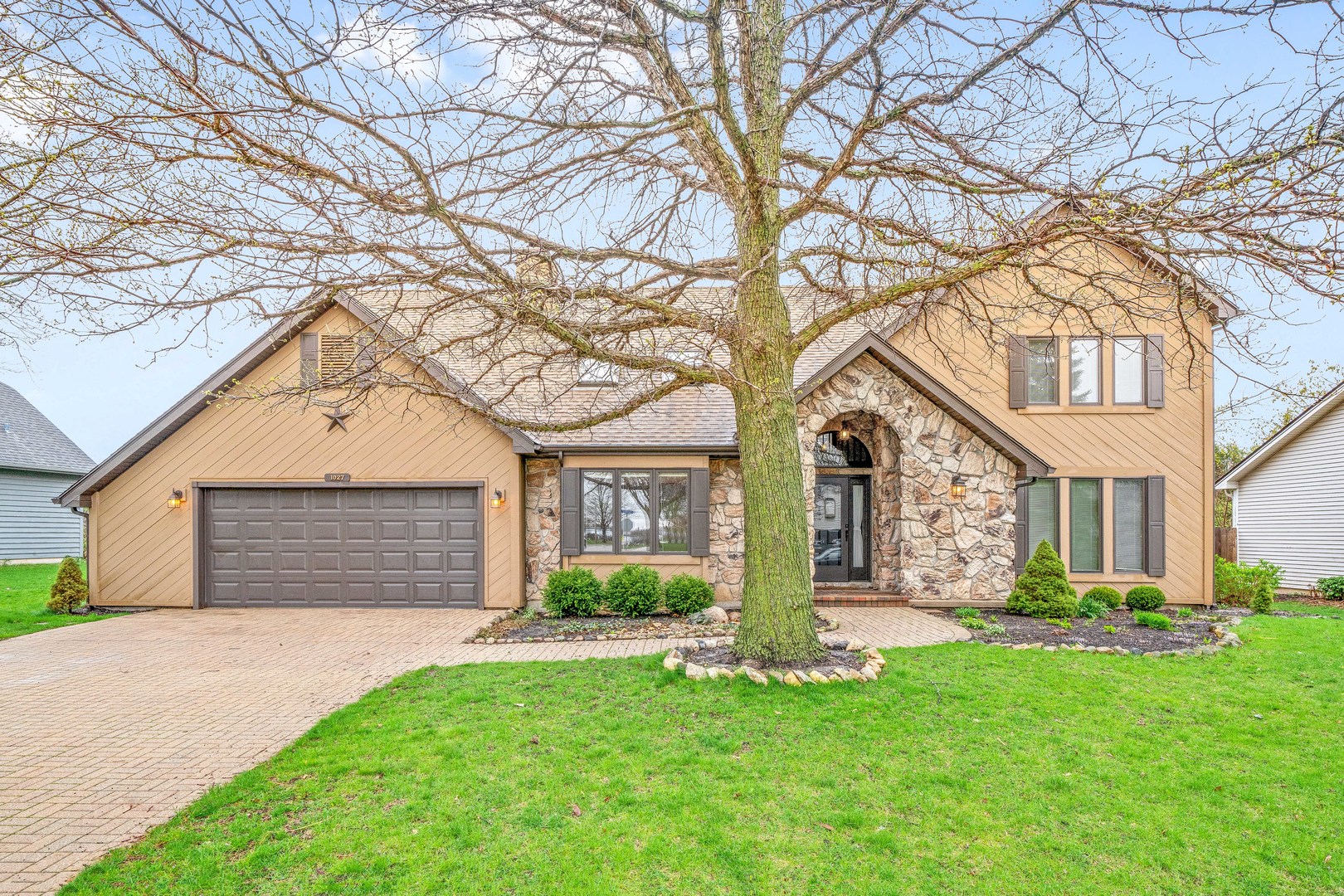 front view of a house and a yard with palm trees