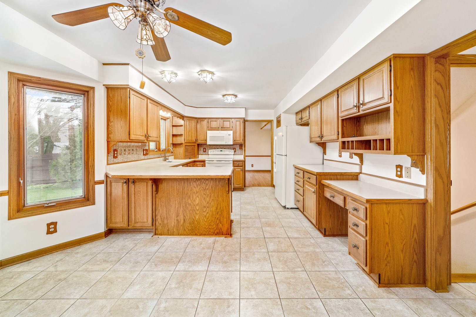 1027 Foxpointe Drive Sycamore, IL 60178 - Photo 15 of 36 a large kitchen with stainless steel appliances granite countertop a large counter top a stove a chimney a sink and dishwasher
