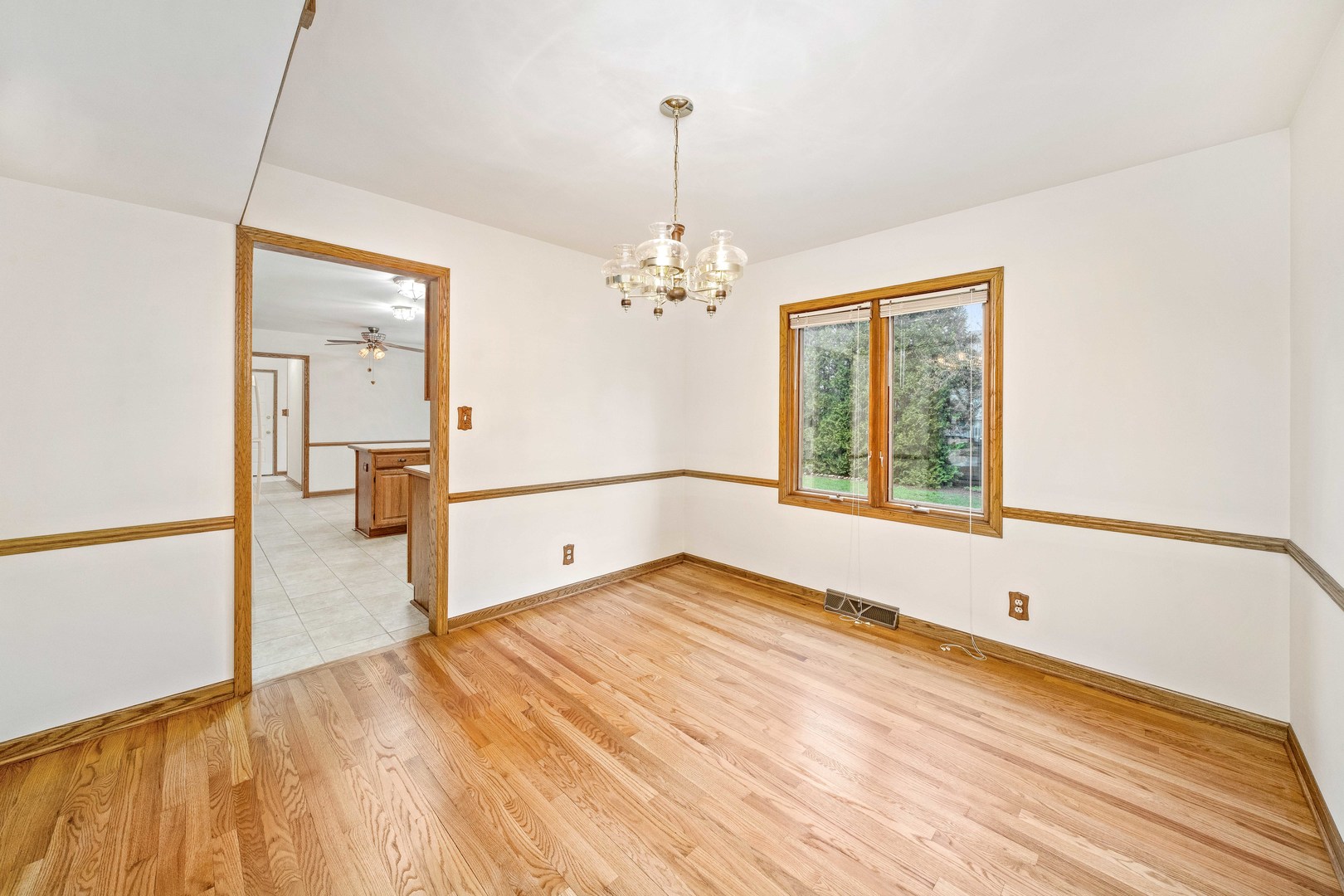 1027 Foxpointe Drive Sycamore, IL 60178 - Photo 21 of 36 a view of a room with wooden floor and a chandelier