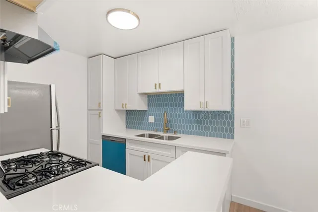 a kitchen with a sink stove and refrigerator
