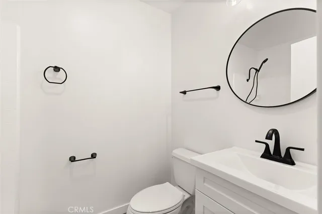 a bathroom with a sink mirror and toilet
