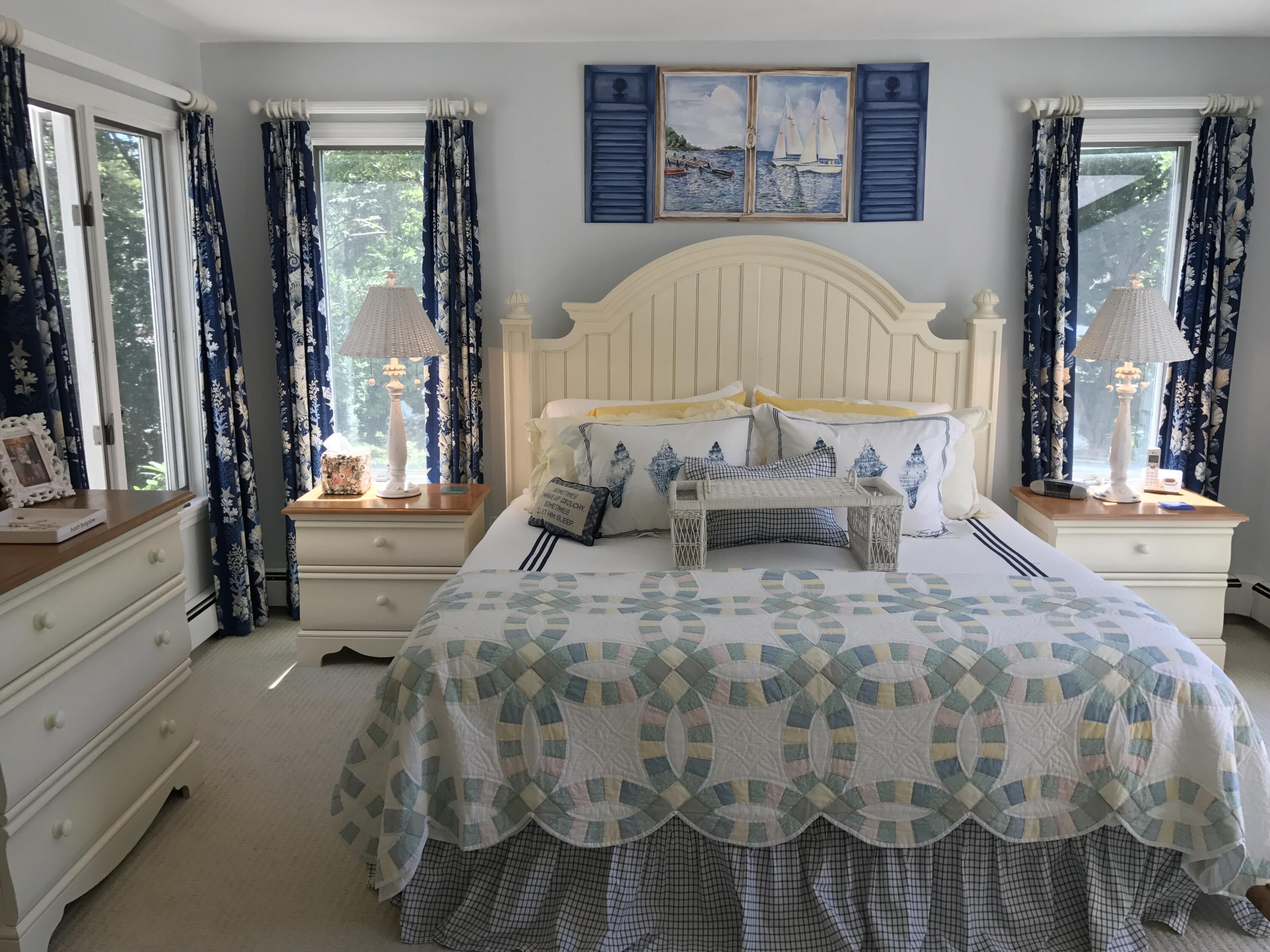 182 Sesuit Neck Road East Dennis, MA 02641 - Photo 16 of 35 a bedroom with a bed and large windows