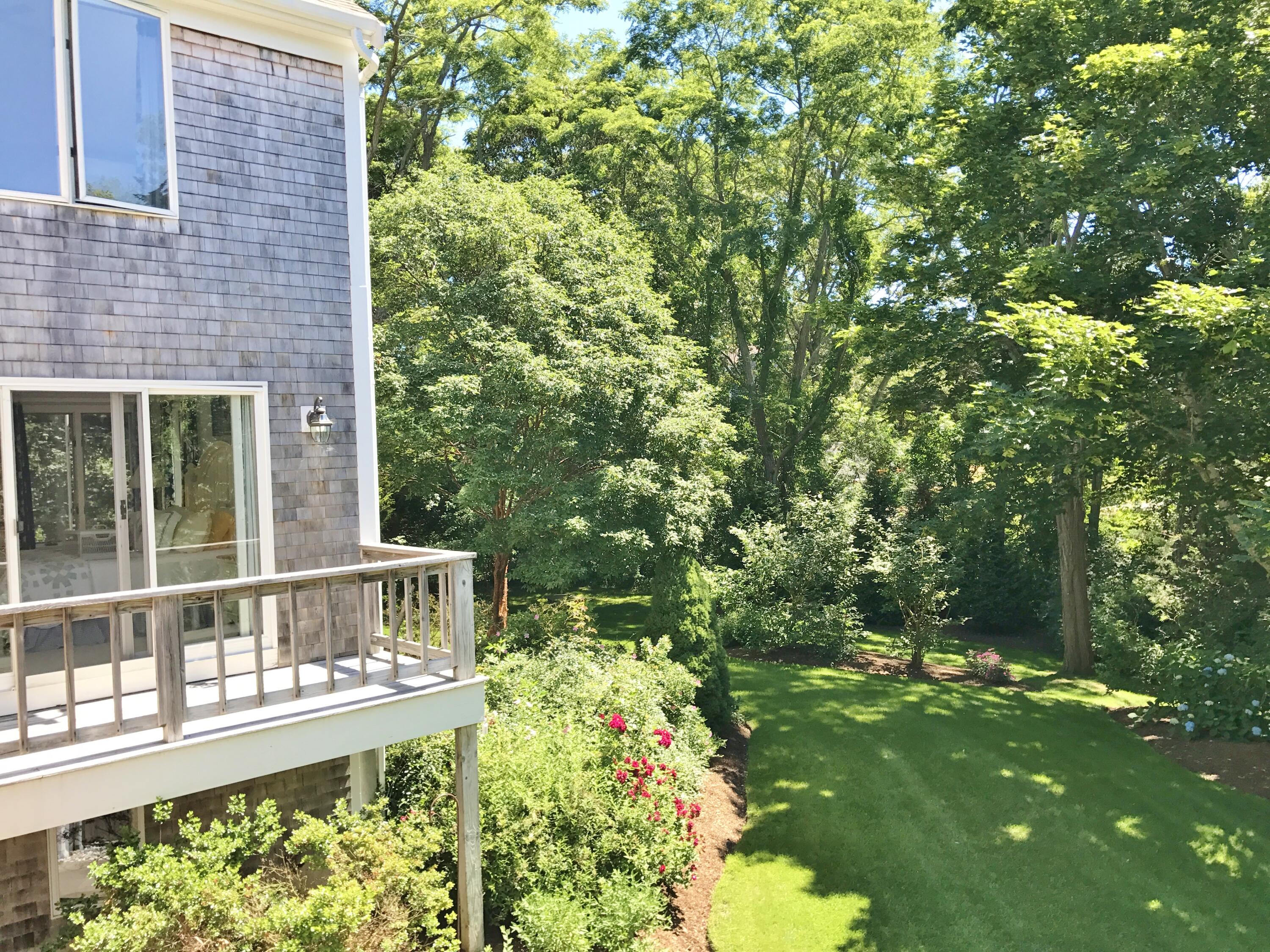 182 Sesuit Neck Road East Dennis, MA 02641 - Photo 19 of 35 a balcony with tall trees