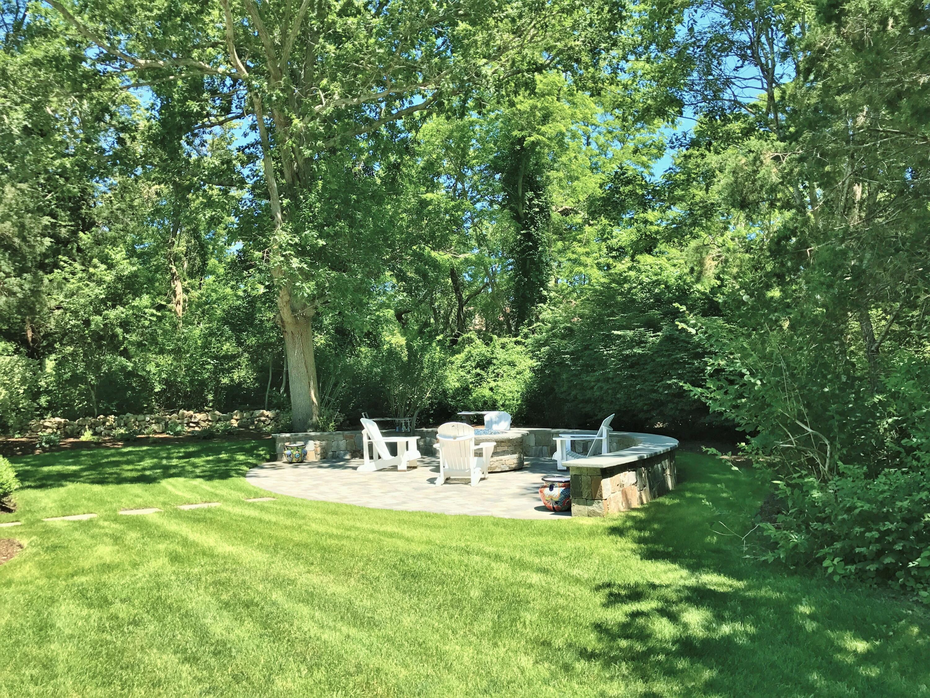 182 Sesuit Neck Road East Dennis, MA 02641 - Photo 35 of 35 a view of a chair and tables in the back yard