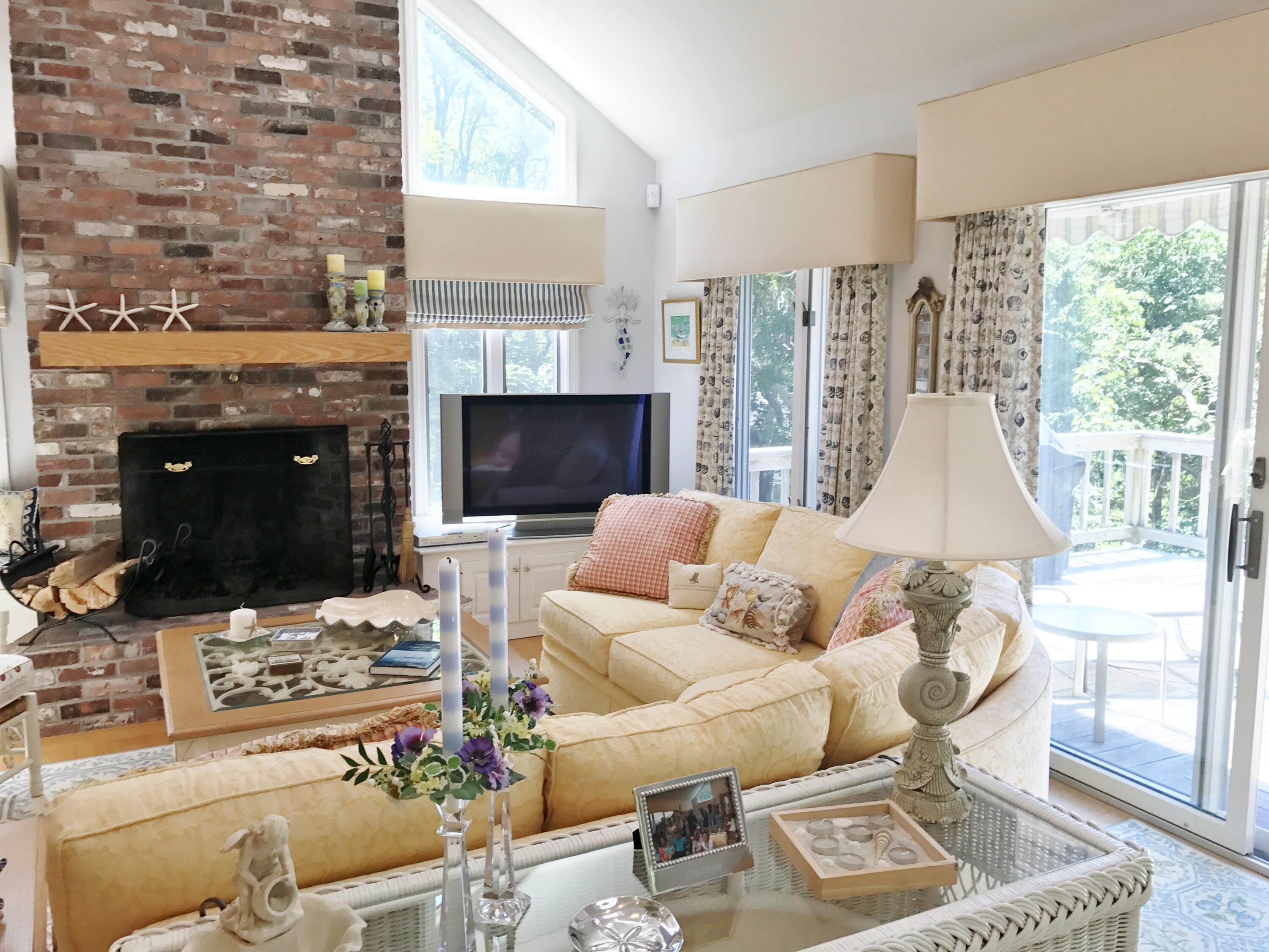 182 Sesuit Neck Road East Dennis, MA 02641 - Photo 6 of 35 a living room with furniture and a fireplace