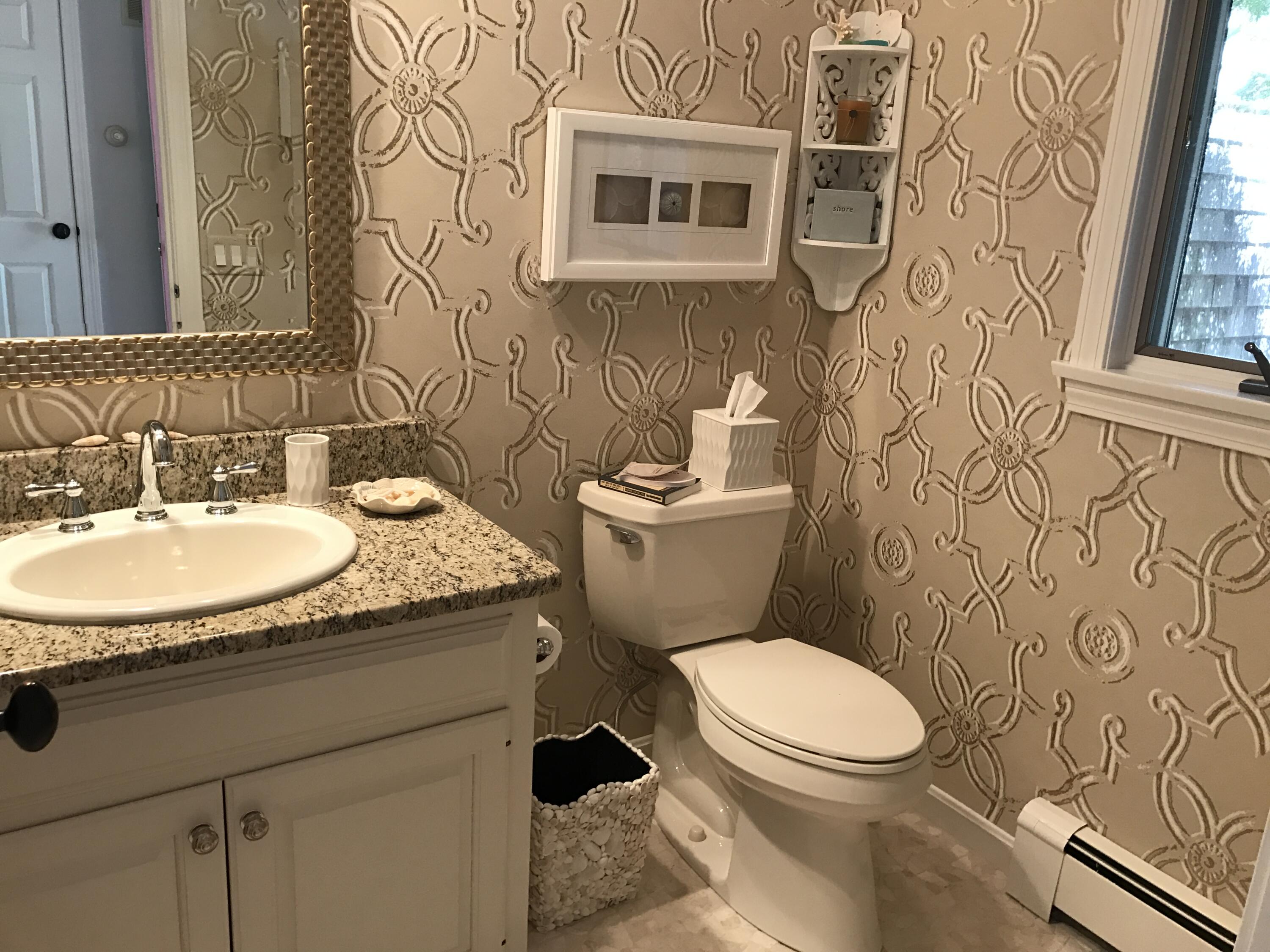 182 Sesuit Neck Road East Dennis, MA 02641 - Photo 10 of 35 a bathroom with a granite countertop toilet sink and mirror