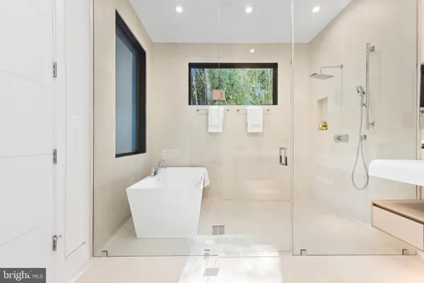 a bathroom with a bathtub and a shower