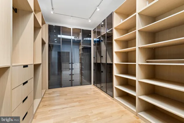 a view of closet area with empty racks