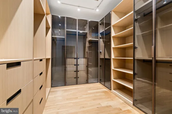 a view of walk in closet with empty racks