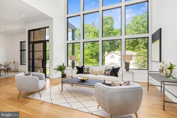 a living room with furniture and large windows