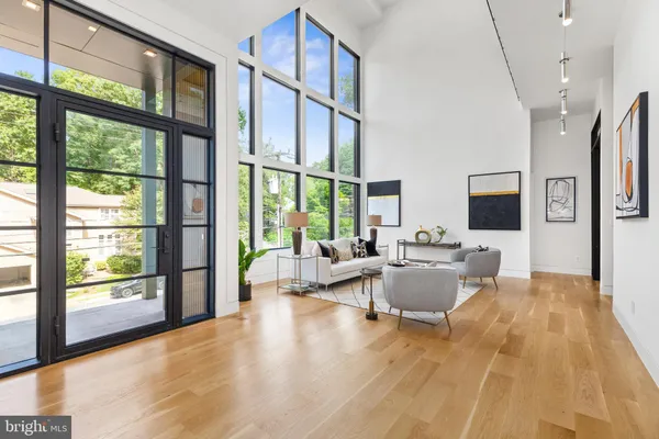 a living room with couches a coffee table and a flat screen tv