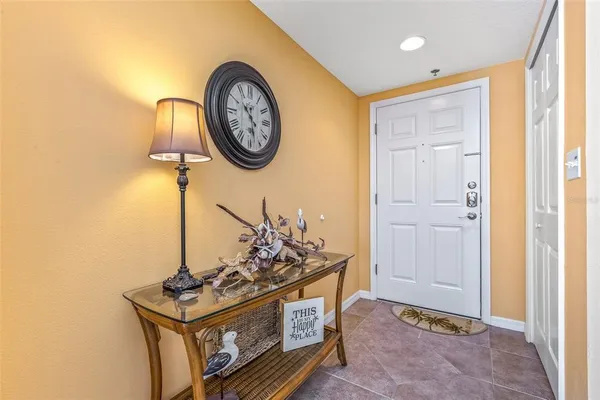 a living room with furniture kitchen view and a chandelier