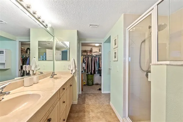 a spacious bathroom with a tub sink and mirror