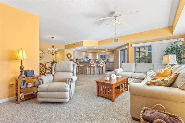 a living room with furniture a rug and a large window